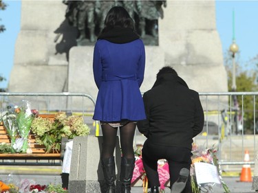 Although much of the area around the National War Memorial and Parliament is still blocked off with police barriers, people were allowed to pay their respects Thursday, laying flowers and notes for the soldier killed in the terrorist attack Wednesday in Ottawa.