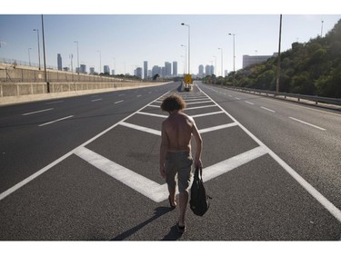 An Israeli man walks on a car-free highway during the Jewish holiday of Yom Kippur in Tel Aviv, Saturday, Oct 4. 2014. Israelis are marking the holiday of Yom Kippur, or 'Day of Atonement,' which is the holiest of Jewish holidays when observant Jews atone for the sins of the past year and the Israeli nation comes to almost a complete standstill.