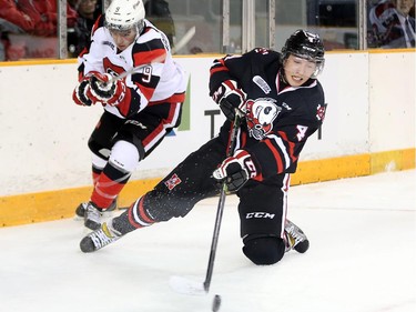 Andrew Abou-Assaly, left, draws a hooking penalty as Ice Dog player Vince Dunn is upended in the first period as the Ottawa 67's take on the Niagara Ice Dogs in their home opener at the renovated TD Place arena.