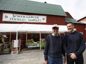 Andrew Harkness, right, shown with his father-in-law John Seabrook, owns the barn that houses many of the vendors at the North Gower Farmer's Market. He and his wife Carolyn started the market 20 years ago.