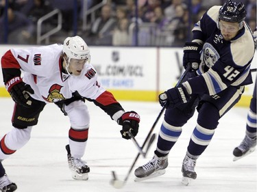 Columbus Blue Jackets' Artem Anisimov, right, of Russia, dumps the puck as Ottawa Senators' Kyle Turris defends during the second period.