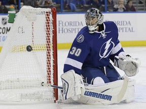 Tampa Bay Lightning goalie Ben Bishop (30) makes a stick save on a shot by the Florida Panthers during the first period of an NHL preseason hockey game Saturday, Oct. 4, 2014, in Tampa, Fla.