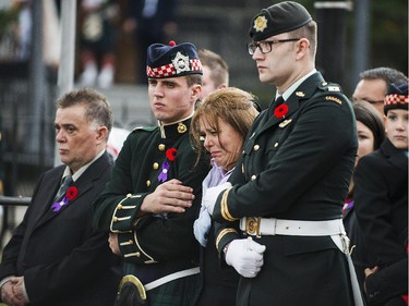 Kathy Cirillo, third from left, the wife of Cpl. Nathan Cirillo, Laureen Cirillo, mourns as her son Marcus Cirillo, right, looks on during Nathan Cirillo's funeral at Christ's Church Cathedral.