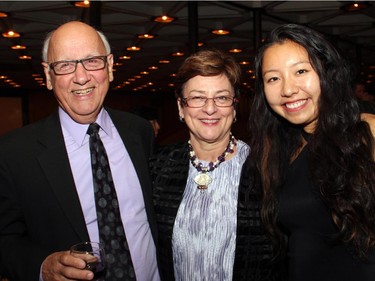 Bill Caswell, chair of Ottawa Singers, with Sharon McGarry, president of Hulse, Playfair &; McGarry, and Yawen Han at the Ottawa Symphony Orchestra's Fanfare post-concert reception held Monday, Oct. 6, 2014, at the National Arts Centre.