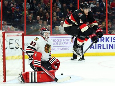 Bobby Ryan of the Ottawa Senators jumps out of the way of a snapshot as Scott Darling of the Chicago Blackhawks makes the save during third period NHL action.