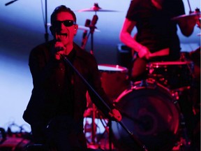 U2 members Bono, left, and Larry Mullen Jr. perform during an announcement of new products by Apple on Tuesday, Sept. 9, 2014, in Cupertino, Calif.