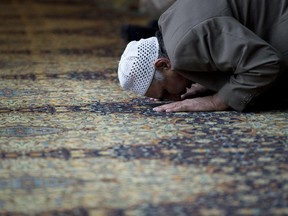 A muslim man prays.