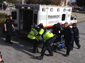 Police and paramedics transport Cpl. Nathan Cirillo who was shot at the War Memorial in Ottawa, OCt. 22, 2014.