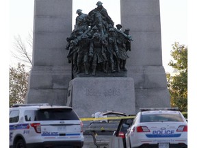 Forensic police officers work near the National War Memorial in Ottawa, Canada on Wednesday October 22, 2014. A gunman opened fire at the National War Memorial killing  a soldier before entering Parliament Hill firing several shots in the building.