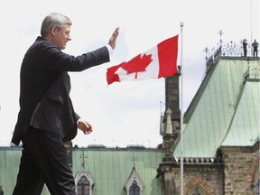 Prime Minister Stephen Harper waves after addressing the Canada Day event on Parliament Hill Sunday July 1, 2012 in Ottawa.