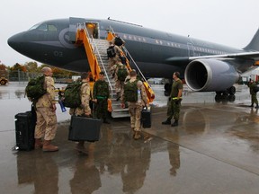 Canadian forces members board a waiting Airbus CC-150 Polaris at CFB Trenton in October, bound for the Middle East.