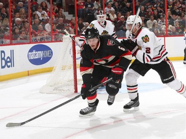 Bobby Ryan #6 of the Ottawa Senators skates against Duncan Keith #2 of the Chicago Blackhawks as Scott Darling #33 of the Chicago Blackhawks looks on.