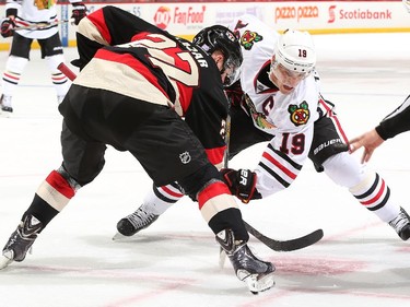 Curtis Lazar #27 of the Ottawa Senators faces off against Jonathan Toews #19 of the Chicago Blackhawks.