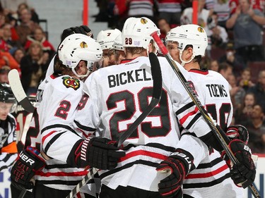 Jonathan Toews #19 of the Chicago Blackhawks celebrates his first period goal with team mates Duncan Keith #2 and Bryan Bickell #29.