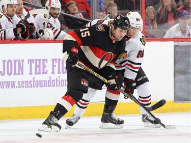 Zack Smith #15 of the Ottawa Senators battles for position against Patrick Kane #88 of the Chicago Blackhawks.