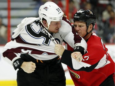 Chris Neil, right, and Cody McLeod square off in the second period.