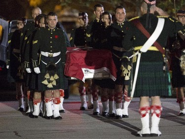 The body of Cpl Nathan Cirillo is carried by his fellow soldiers into the Dermody-Markey Funeral Home in Hamilton, Ontario on Friday, Oct. 24, 2014. The 24-year-old reservist was gunned down as he stood ceremonial guard at the National War Memorial in Ottawa on Wednesday.