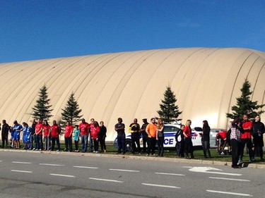 Citizens gather along West Hunt Club to watch Cpl Cirillo pass by on his way to Hamilton.