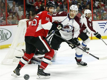 Clarke MacArthur, left, and Brad Stuart look to find the puck in the first period.