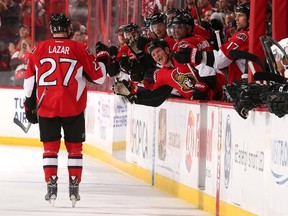 OTTAWA, ON - OCTOBER 16: Chris Neil #25 of the Ottawa Senators celebrates a first period goal against the Colorado Avalanche with teammate Curtis Lazar #27 at Canadian Tire Centre on October 16, 2014 in Ottawa, Ontario, Canada.