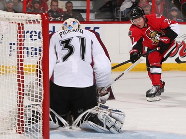 Curtis Lazar #27 of the Ottawa Senators shoots the puck against Calvin Pickard #31 of the Colorado Avalanche.