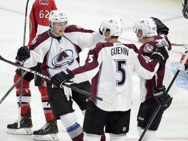 Colorado Avalanche's Alex Tanguay (40) celebrates his goal against the Ottawa Senators with teammates Nathan MacKinnon (29) and Nate Guenin (5) during first period NHL action.