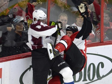 Colorado Avalanche's Jan Hejda (8) collides with Ottawa Senators' Zack Smith (15) during first period NHL action.