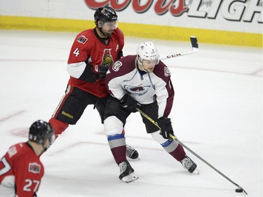 Colorado Avalanche's John Mitchell (1) battles Ottawa Senators' Chris Phillips (4) during second period NHL action.