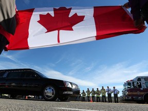 Cpl. Nathan Cirillo's is transported by hearse from Ottawa to Hamilton via the Highway of Heroes, October 24, 2014. (Jean Levac/ Ottawa Citizen)