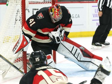 Craig Anderson of the Ottawa Senators makes the save as Zack Smith looks on against the Chicago Blackhawks during second period NHL action.