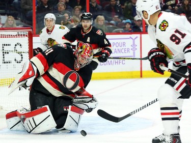 Craig Anderson of the Ottawa Senators makes the save on Brad Richards, right, of the Chicago Blackhawks during second period NHL action.