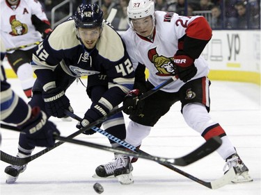 Ottawa Senators' Curtis Lazar, right, and Columbus Blue Jackets' Artem Anisimov, of Russia, chase a loose puck during the first period.