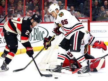 Curtis Lazar, left, of the Ottawa Senators attacks Andrew Shaw (65) of the Chicago Blackhawks during first period NHL action.