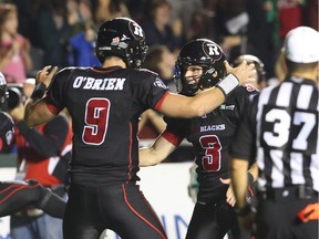 Danny O'Brien, left, of the Ottawa RedBlacks celebrates his touchdown pass with Brett Maher against the Winnipeg Blue Bombers during first half CFL action.