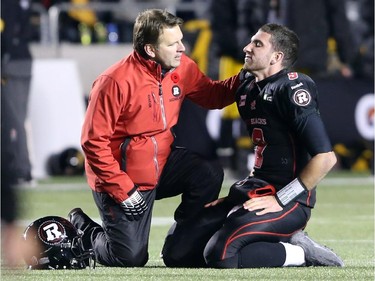 Danny O'Brien of the Ottawa Redblacks takes a breather after being hit by the Hamilton Tiger-Cats during first half CFL action.