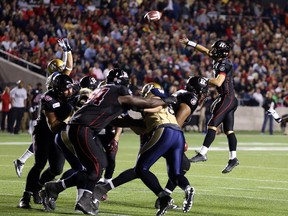Danny O'Brien of the Ottawa RedBlacks throws a touchdown against the Winnipeg Blue Bombers during first half CFL action.