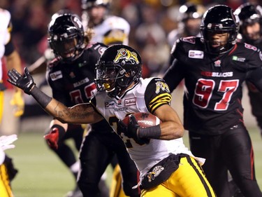 Delvin Breaux of the Hamilton Tiger-Cats runs the ball against the Ottawa Redblacks during first half CFL action.