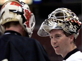 1998 file photo: The Ottawa Senators  at practice in the  Corel Centre.  Ron Tugnutt talks to Damian Rhodes during practice.