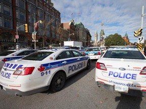 Elgin Street is locked down as police respond to an apparent terrorist attack in Ottawa.  Assignment - 118747 // Photo taken at 10:16 on October 22, 2014. (Wayne Cuddington/Ottawa Citizen) ORG XMIT: POS1410221025402516   (add: shooting ottawa, suspect: Michael Zehaf-Bibeau, victim: Nathan Cirillo)