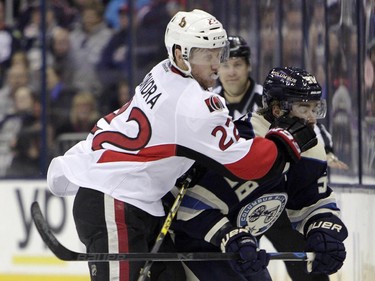 Ottawa Senators' Erik Condra, left, checks Columbus Blue Jackets' David Savard during the second period.