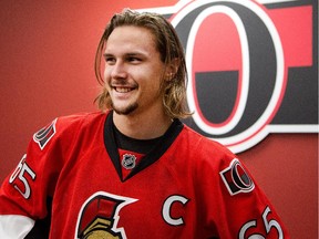 Erik Karlsson is all smiles as he sports the C.