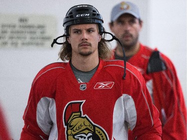 Erik Karlsson is followed by Chris Phillips into the arena as the Ottawa Senators practice Wednesday afternoon at the Bell Sensplex.