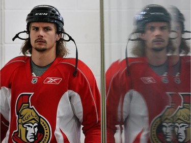Erik Karlsson is reflected in the rink glass as the Ottawa Senators practice Wednesday afternoon at the Bell Sensplex.
