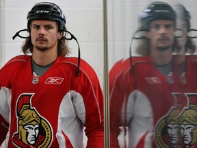 Captain Erik Karlsson is reflected in the rink glass as the Ottawa Senators prepare for the season.