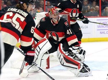 Erik Karlsson, left, Craig Anderson and Chris Phillips, right, of the Ottawa Senators against the Chicago Blackhawks during second period NHL action.