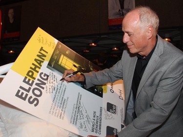 Film director Charles Binam� signs the movie poster for Elephant Song at its Ottawa premiere, held at the National Arts Centre on Monday, Sept. 29, 2014.