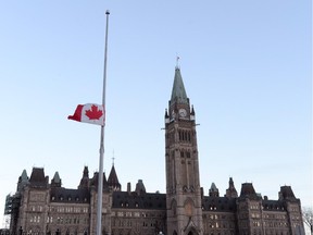 Flags fly at half mast on Parliament hill and on the Peace Tower in Ottawa on Thursday October 23, 2014. A gunman turned the nation's capital into an armed camp Wednesday after he fatally shot an honour guard at "point-blank" range at the National War Memorial before setting his sights on Parliament Hill.