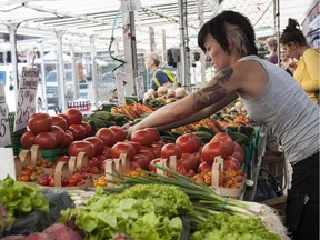 for Bruce Deachman  tablet featureEmilie Diotte arranges produce at a ByWard Market stall.