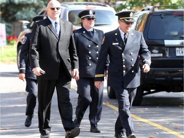 Former Ottawa Chief of Police, now Senator, Vern White, left, arrives at the funeral for Staff Sgt. Kal Ghadban.