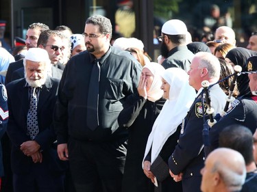 Friends and family console each other after the funeral for Staff Sgt. Kal Ghadban.